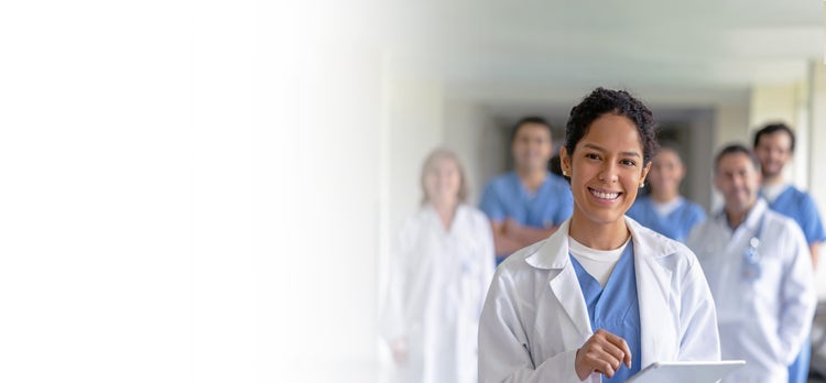 Doctor stands in front of another group of doctors